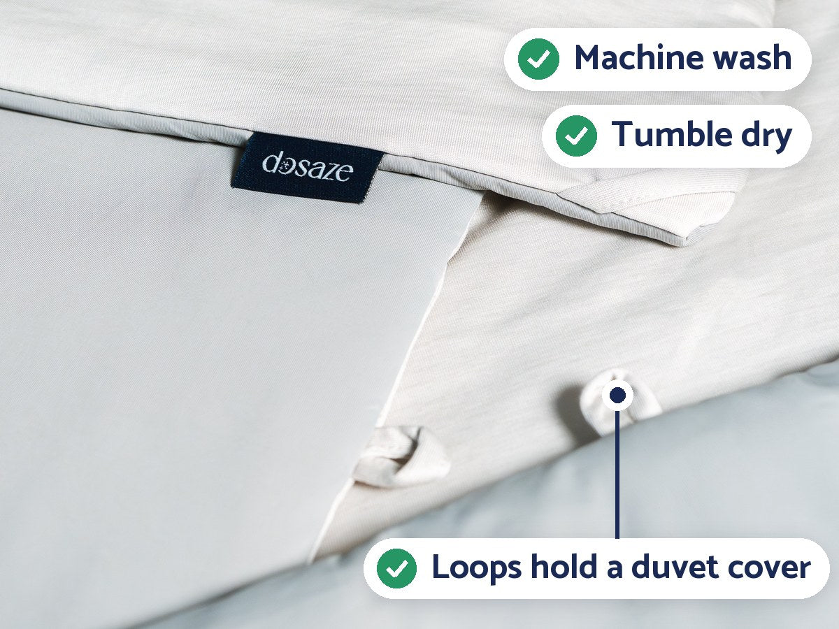 Close-up of the Dosaze ThermaCool Comforter with its label and corner loops, labeled: machine wash, tumble dry, loops hold a duvet cover.